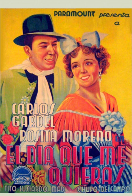 El día que me quieras. Plakaten viser Carlos Gardel og Rosita Moreno fra filmen "El día que me quieras". Paramount presenterer. To personer smiler, fargerik bakgrunn og blomster.